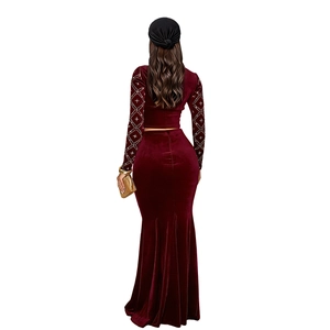 Detail of burgundy velvet top with elegant rhinestone patterns and long mermaid skirt