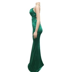 Detail view of emerald green satin evening gown featuring an open back and sleek mermaid cut