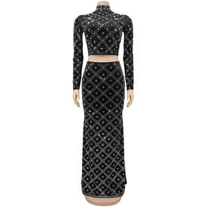 Detail of elegant black velvet two-piece set featuring diamond lattice and pearl beadwork