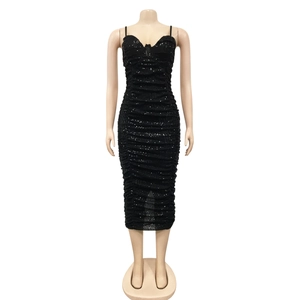 Detail of black sequined midi dress with elegant side slit and ruched texture fabric