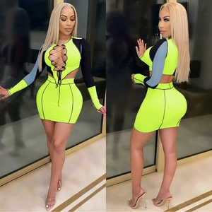 Detail of neon yellow ribbed knit two-piece set with front lace-up and cutout design