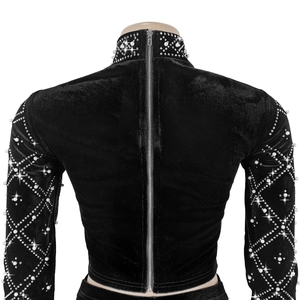 Close-up of black velvet cropped top featuring back zipper and pearl rhinestone patterns