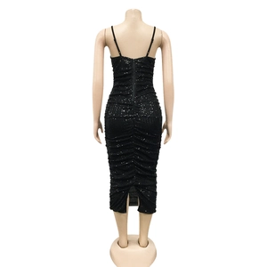 Detail of black sequined dress showing back zipper closure and slim fit silhouette