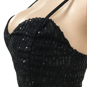 Close-up of black sequined fabric detailing with thin shoulder straps on a dress