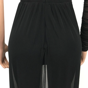 Detail of sheer black mesh jumpsuit showing fabric texture and back pleats
