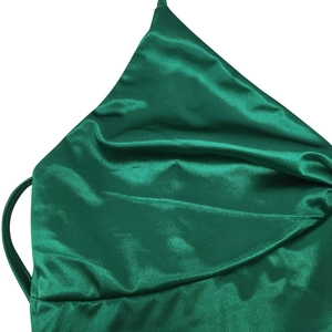 Detail of dark green satin cowl neck dress with delicate straps and elegant fabric texture
