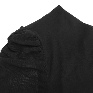 Close-up of semi-transparent black mesh fabric with ruched shoulder detail and puff sleeve