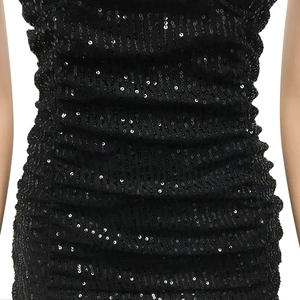 Close-up of black sequined evening dress with ruched fabric details and shimmering finish