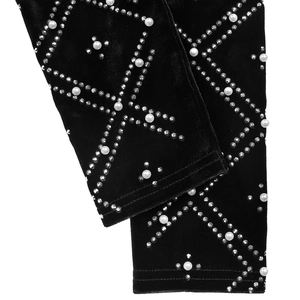 Detailed view of luxury black velvet fabric with hand-applied white pearls and rhinestones