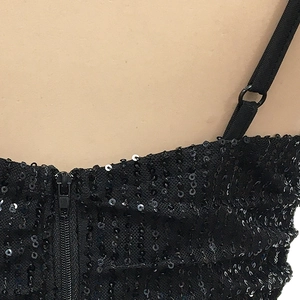 Close-up of black sequin dress with adjustable straps and high-quality zipper detail