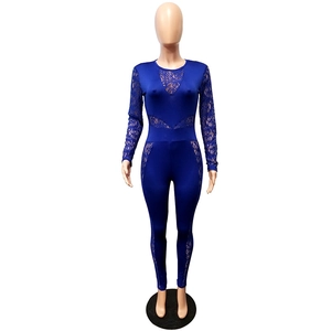 Detail of royal blue lace patchwork jumpsuit with long sleeves and sheer mesh inserts