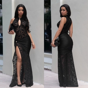 Detail of elegant black lace and satin evening dress featuring high slit and halter neck