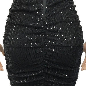 Detail view of black sequin dress showing vertical silver sequins and a zipper closure