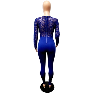 Detail view of deep blue lace jumpsuit featuring floral textures and back metal zipper