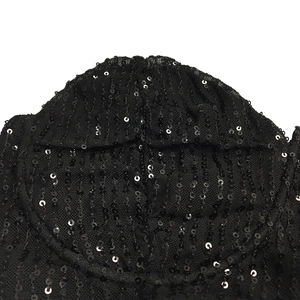 Close-up of black sequin embroidery on mesh fabric for a sparkling cocktail dress