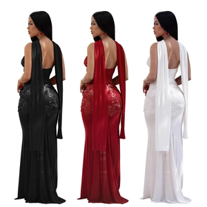 Detail of sequined fishtail evening gowns with open back and long shoulder streamers