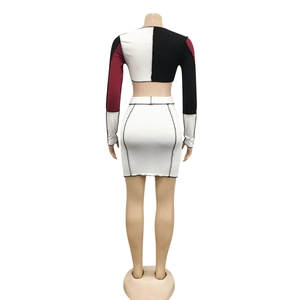 Detail of two-piece crop top and mini skirt set with contrast stitching on ribbed fabric