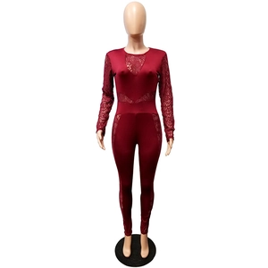 Detail of burgundy jumpsuit featuring elegant lace patchwork on long sleeves and chest area
