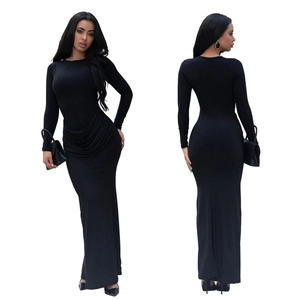 Detail of elegant black long sleeve maxi dress with shimmering fabric and waist draping