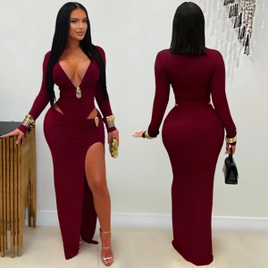 Deep V-neck burgundy dress featuring symmetrical side cut-outs and gold metal buckles