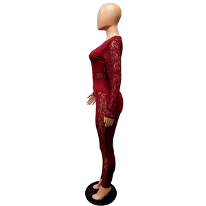 Detailed view of the sheer floral lace stitching on burgundy long sleeve jumpsuit