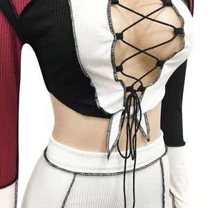Close-up of color-block knit mini dress set with criss-cross lace-up chest detail