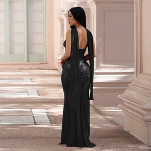 Detail of black sequined evening gown featuring elegant cape sleeves and slim fit design