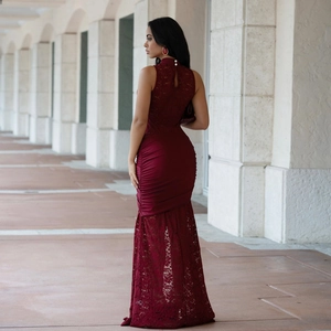 Detail of burgundy lace dress featuring sleeveless high neck and back cutout with pearls