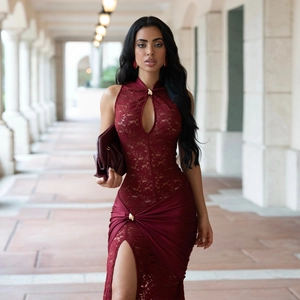 Detail of wine red lace dress featuring high neck cutout and gold button closure