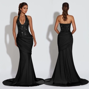 Elegant black halter evening gown with sequined bodice and cross-back tie design detail