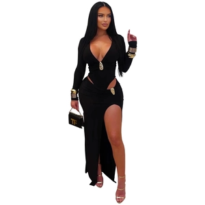 Detail of elegant black long sleeve maxi dress featuring deep V-neck and gold buckle waist cut-out