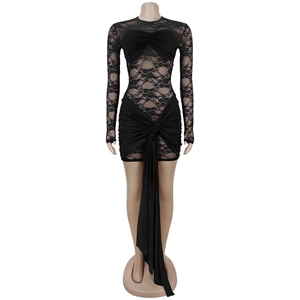 Detail of black lace dress showing sheer floral texture and elegant draped waist ribbons