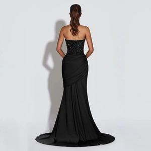Detail of sequined bodice with lace-up back on elegant black halter mermaid evening gown