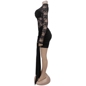 Detail view of lace sleeve and side ruching on a sexy black bodycon party dress