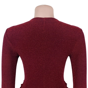 Detail view of the back of a slim-fit burgundy dress featuring shiny metallic glitter fabric