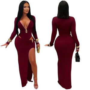 Detail of burgundy V-neck dress with waist cut-outs, metal buckles, and a high side slit