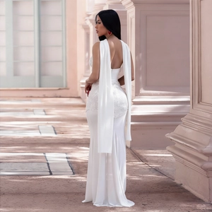 Close-up of elegant white sequins and beadwork detail on a mesh V-neck evening gown