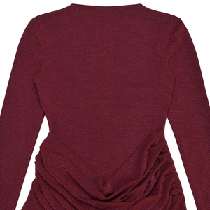 Close-up of elegant burgundy glitter dress showing back slit and ruched fabric texture