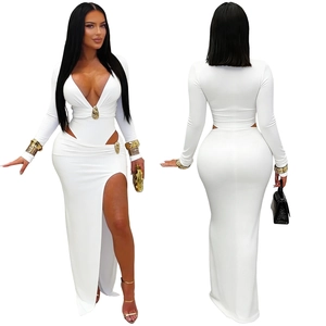 Detail of white deep V-neck dress featuring gold hardware accents and side cut-outs