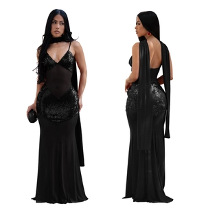 Detail of a black sequin dress with mesh waist cutout and long shoulder streamers