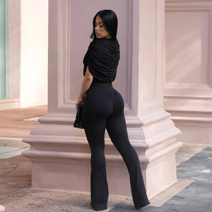 Detail view of black slim fit jumpsuit featuring elegant ruched texture and high waist design
