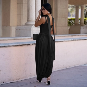 Elegant black halter maxi dress featuring long back streamers and delicate pleated fabric