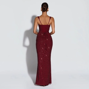 Détail d'une robe de soirée à paillettes bordeaux avec dos nu et fermeture à lacets