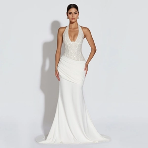 Detailed view of white halter neck evening gown featuring sequined bodice and elegant draped folds