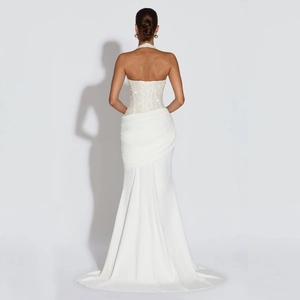 Detailed view of white mermaid dress with lace-up back and sequin embroidery