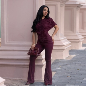 Elegant deep burgundy slim-fit jumpsuit with pleated bodice and flared leg pants
