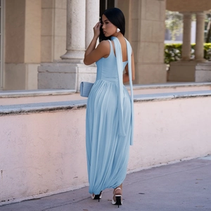 Detailed view of elegant light blue sleeveless maxi dress with high neck and flowing streamers