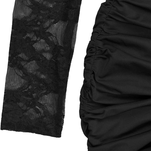 Detailed close-up of floral lace sleeves and black ruched elastic fabric on the dress