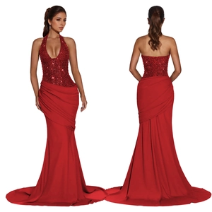 Detail of red sequin halter neck gown with back lacing and elegant satin fishtail train