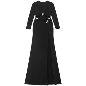 Detail of black V-neck dress with side cut-outs and decorative gold metal buckles